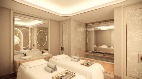 a bathroom with two sinks and a mirror at The Trans Luxury Hotel Surabaya in Surabaya