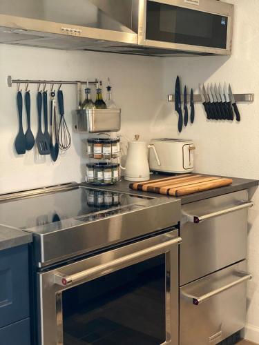 a kitchen with a stainless steel stove and utensils at Apartment in Ft Collins in Fort Collins