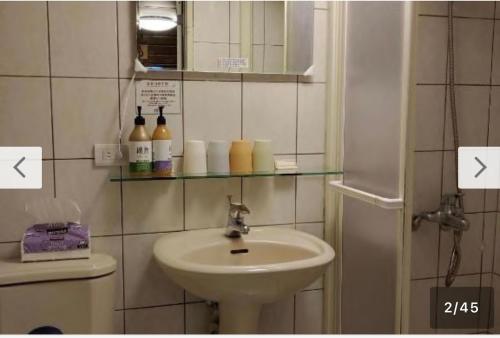 un baño con lavabo e inodoro en 九份迦南民宿, en Jiufen