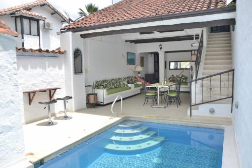 a house with a swimming pool and a patio at Casa Los Almendros in Melgar