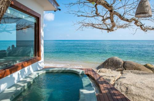 a swimming pool with a view of the ocean at Rocky's Boutique Resort - Veranda Collection Samui in Lamai