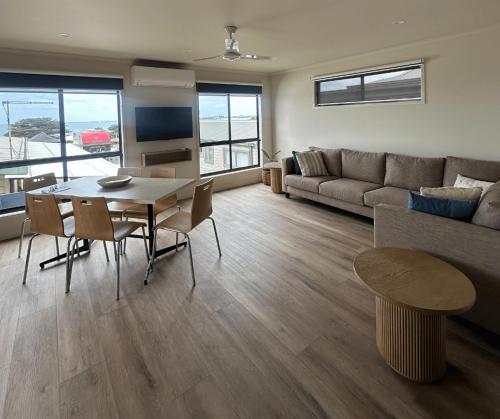a living room with a table and a couch at BIG4 Apollo Bay Pisces Holiday Park in Apollo Bay