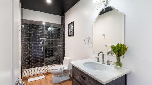 a bathroom with a sink and a toilet and a shower at Rock n Roll by AvantStay Vibey 2BDR in Prime Hollywood Steps to Attractions in Los Angeles