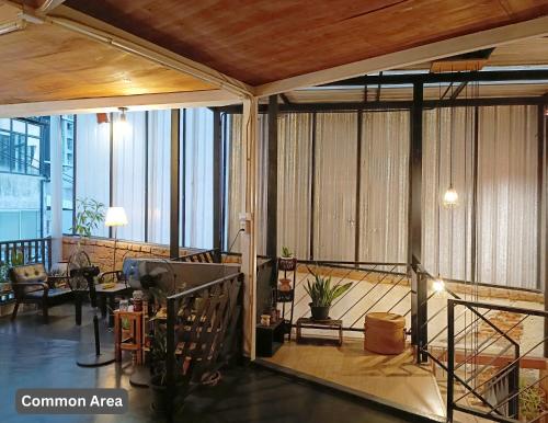 a room with a balcony with a living room at Friend Nest Bangkok in Bangkok