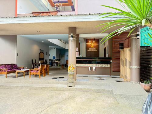 a house with a palm tree in the middle of a patio at Chedi Chiangrai Boutique Hotel in Chiang Rai