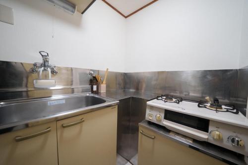 a kitchen with a sink and a stove at 3min walk to Asagaya Sta, Cozy Private Studio Direct access 8min to Shinjuku, 30min to Akihabara and Asakusa in Tokyo