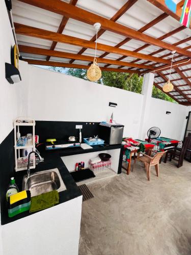 a kitchen with a sink and a table at Anthony Guesthouse in Hikkaduwa