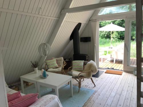 a living room with a table and a fireplace at The Doll House - Adults Only in Ebeltoft