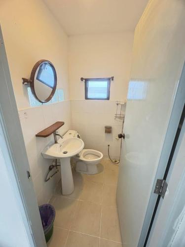 a bathroom with a toilet and a sink and a mirror at cher lonely beach resort Koh chang in Ko Chang