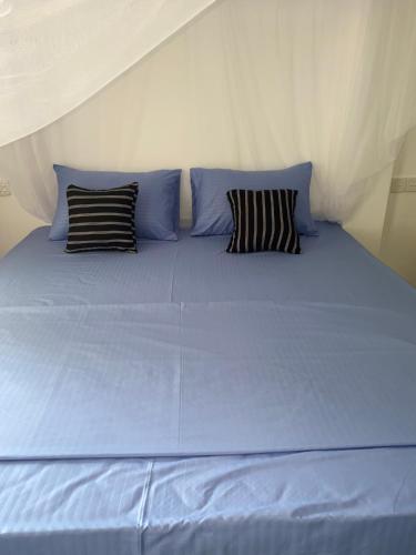 En eller flere senge i et værelse på Relax Corner