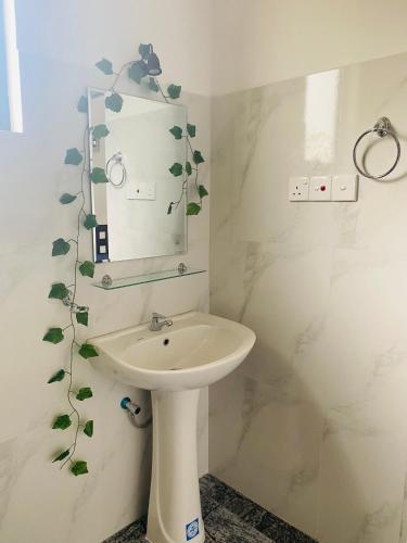 a bathroom with a sink and a mirror at Relax Corner in Hiriketiya