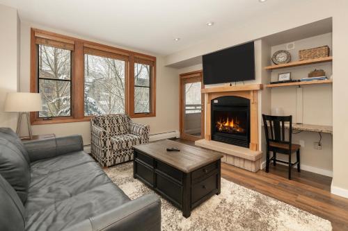 a living room with a couch and a fireplace at Ski-In/Ski-Out Zephyr 1 Bedroom Condo Winter Park in Winter Park