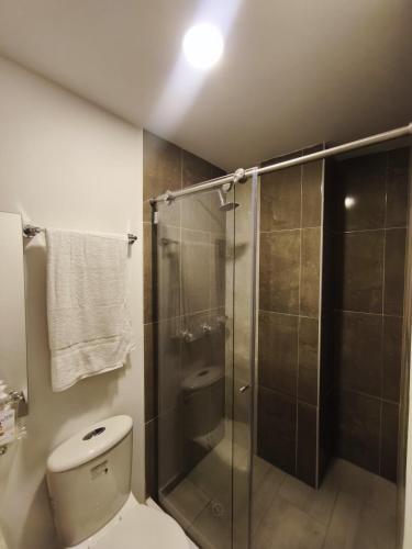 a bathroom with a toilet and a glass shower at Barranquero Coffee Loft in Santa Rosa de Cabal