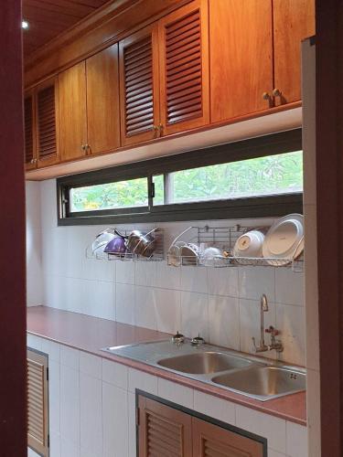 a kitchen counter with a sink and a window at Thai House by Dow Residence in Lamai