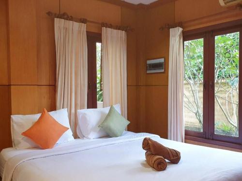 a bedroom with two beds and a window at Thai House by Dow Residence in Lamai
