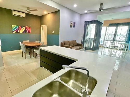 a kitchen with a sink and a living room at IMAGO The Loft Kota Kinabalu City Centre by LW Suites in Kota Kinabalu