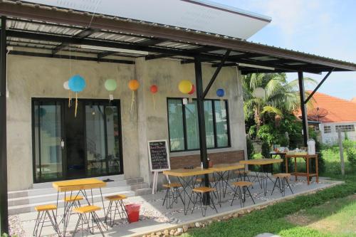 a group of tables and chairs on a patio at Sweet Dreams in Phetchaburi
