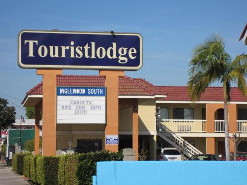 a building with a sign for a hotel at Touristlodge in Inglewood
