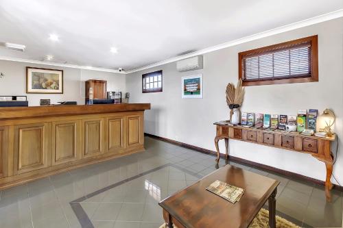a waiting room with a cash register and a table at The Clifton Motel in Bunbury