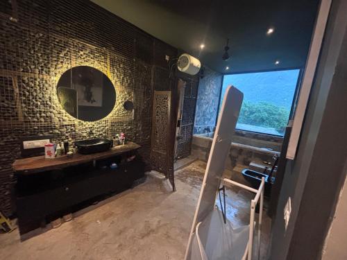a bathroom with a sink and a mirror at Silvaate stay in Karjat