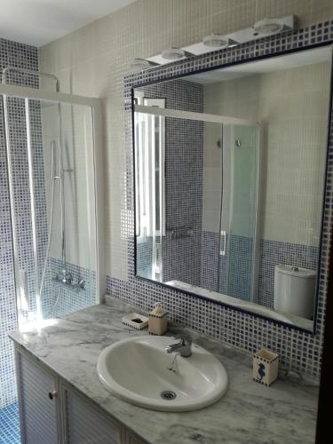 a bathroom with a sink and a mirror at Atico Infanta Eulalia in Sanlúcar de Barrameda