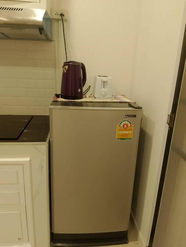 a small refrigerator with a tea kettle on top of it at AURA House in Pattaya South