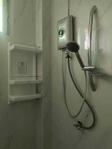 a shower in a bathroom with a hair dryer at AURA House in Pattaya South