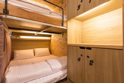 a small bedroom with a bed in an rv at Beimen WOW Poshtel in Taipei