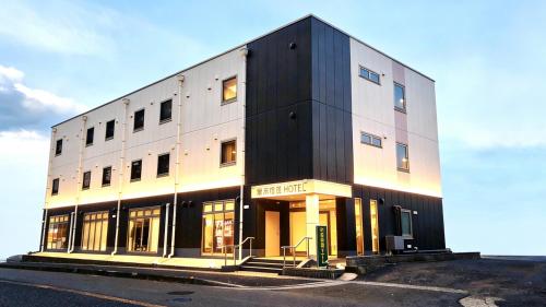 a black and white building on the side of a street at 阪南国际HOTEL in Hannan