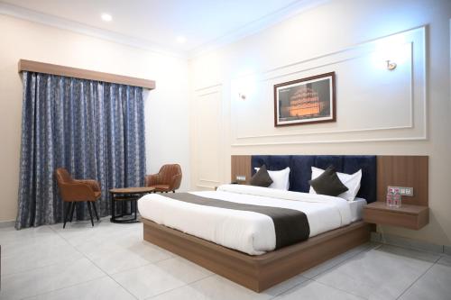 a bedroom with a bed and a desk and a chair at Florian Club Resort and Spa Jaipur in Jaipur