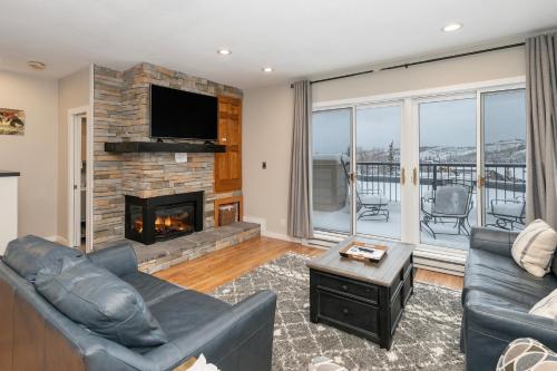 a living room with a couch and a fireplace at Great Location! Downtown WP with Hot Tub! Sleeps 6! in Winter Park