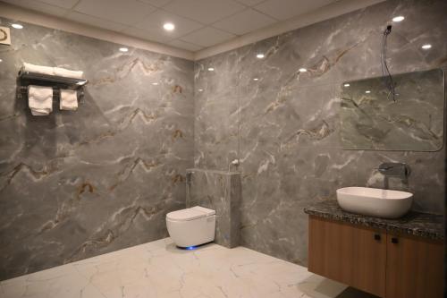 a bathroom with a toilet and a sink at Florian Club Resort and Spa Jaipur in Jaipur