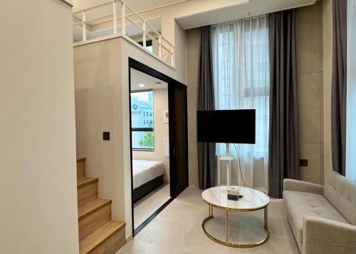 a living room with a couch and a table at Namsan Dream City in Seoul