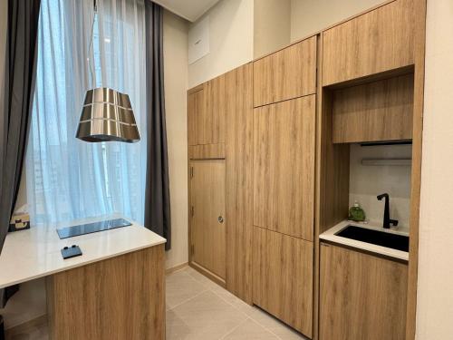 a kitchen with wooden cabinets and a window at Namsan Dream City in Seoul