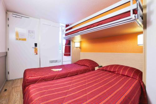 a room with two beds in a hotel room at Premiere Classe La Rochelle Nord - Puilboreau in Puilboreau