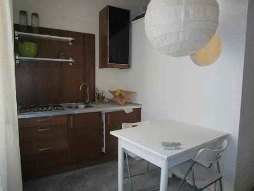 a small kitchen with a white table and a light at Crisalide Mini in Sorano