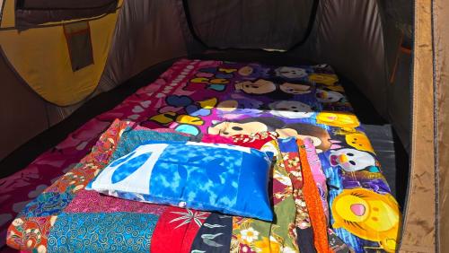 een bed in een tent met knuffels en kussens bij Phulomnum resort in Khao Kho
