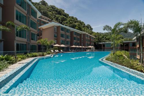 a swimming pool in front of a building at Wyndham Garden Phuket Kamala in Kamala Beach
