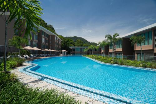 a large swimming pool in front of a building at Wyndham Garden Phuket Kamala in Kamala Beach