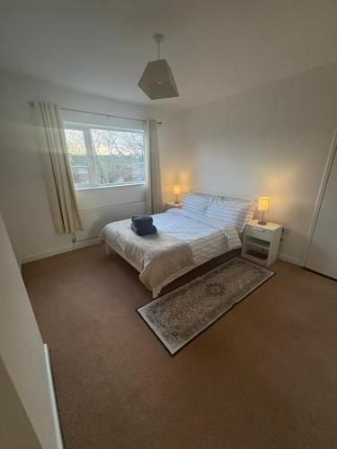 a bedroom with a bed and a window at Cardinal Court , Wilton 3BR Beside CUH Hospital in Cork