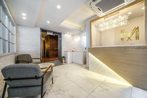 a lobby with a waiting area with chairs and a sign at 광안비치호텔더엠 in Kwangan-dong