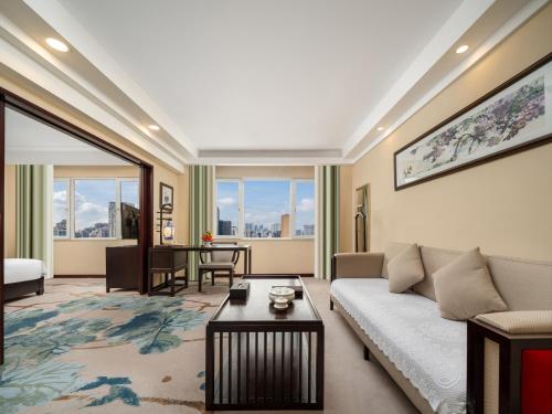 a living room with a couch and a table at Guangdong Hotel in Guangzhou