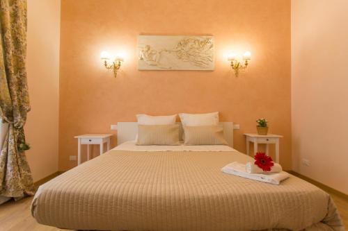 a bedroom with a large bed with two tables at Amedeo Apartment in Rome