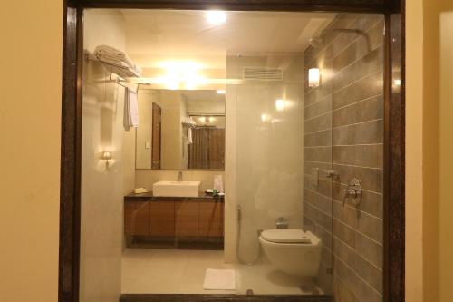 a bathroom with a toilet and a sink at VITS Kamats Resort, Silvassa in Silvassa