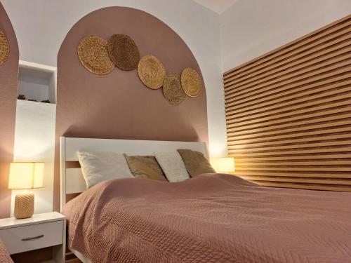 a bedroom with a bed with two mirrors on the wall at Apartment Kate - Old Town in Bratislava