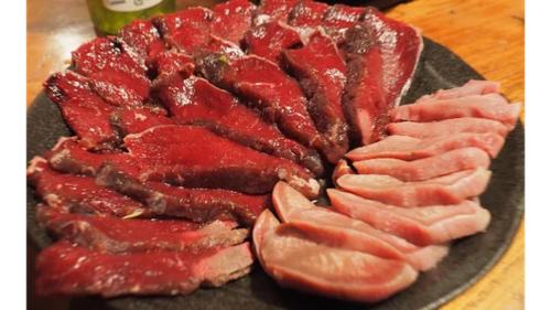 MeraA private log house in a secluded beach, LOGOUT的桌上有肉的盘子