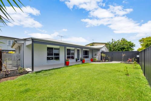 a backyard of a home with a fence at 3 Bedroom Fully Renovated Home away from Home in Brisbane