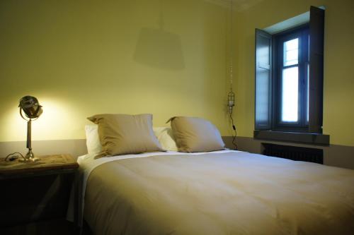 a bedroom with a large white bed with a window at "Apeiros Chora" Hotel, Zagori in Kato Pedina