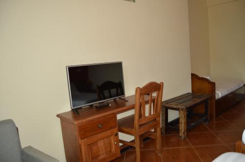 a room with a desk with a tv and a chair at Harbe Hotel in Lalībela