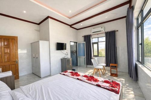 um quarto com uma grande cama branca com rosas em Ngọc Nga Hotel em Phan Rang